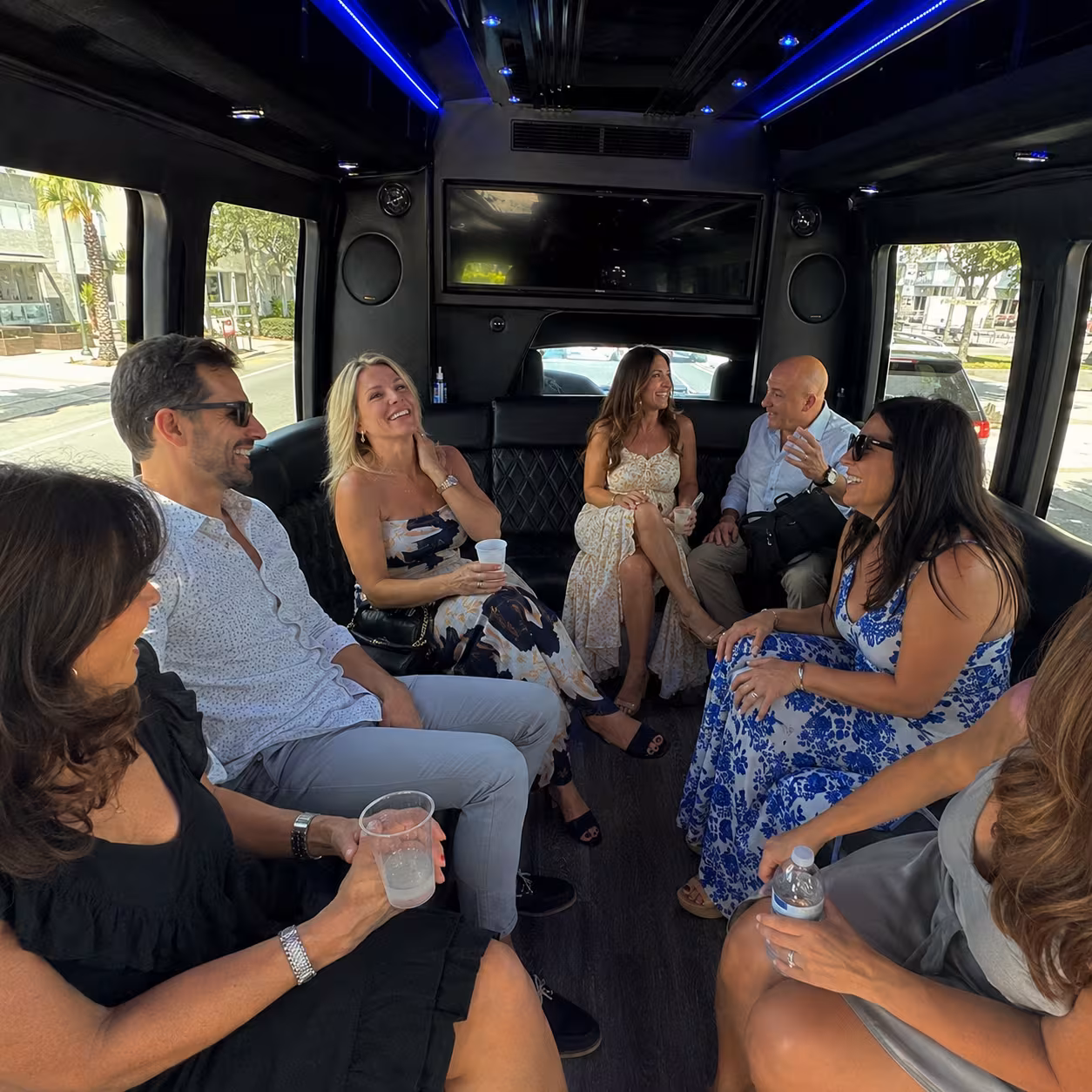Friends laughing during a Naples party bus celebration