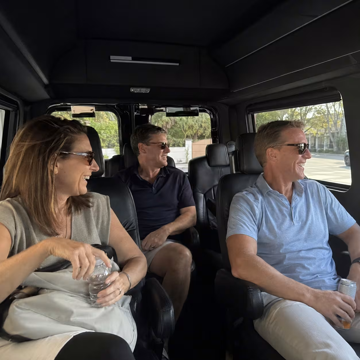 Business travelers seated in a leather Mercedes Sprinter cabin during a Naples, Florida airport transfer