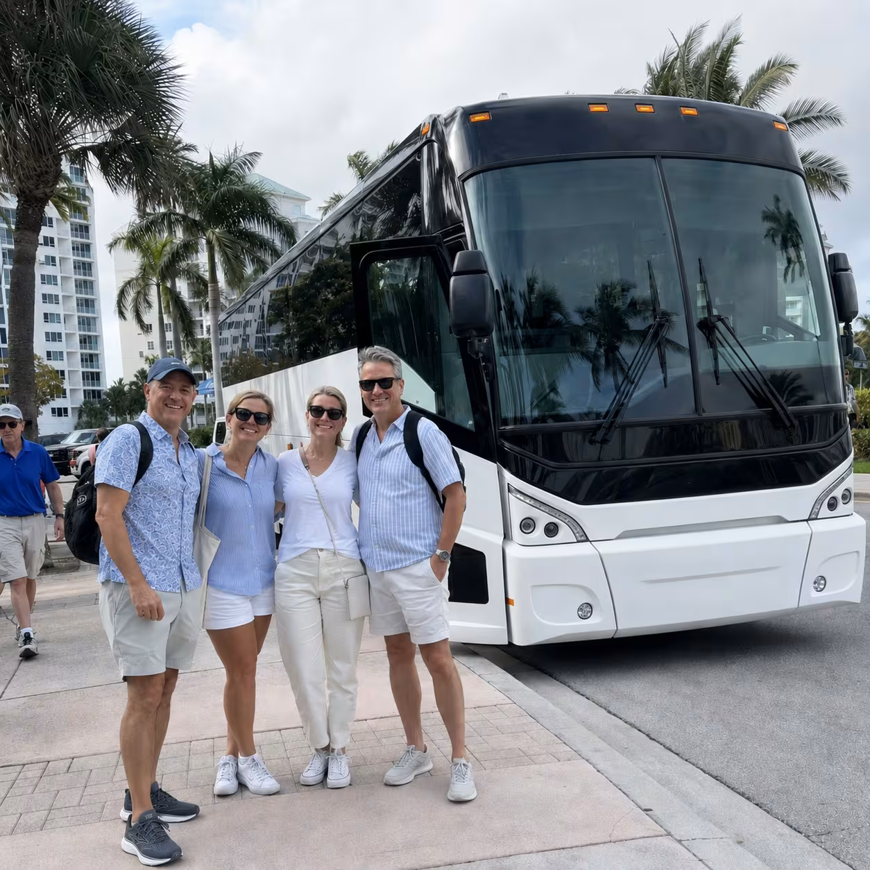 Group luggage being loaded into an MCI J4500 motorcoach at airport arrivals for a Southwest Florida transfer