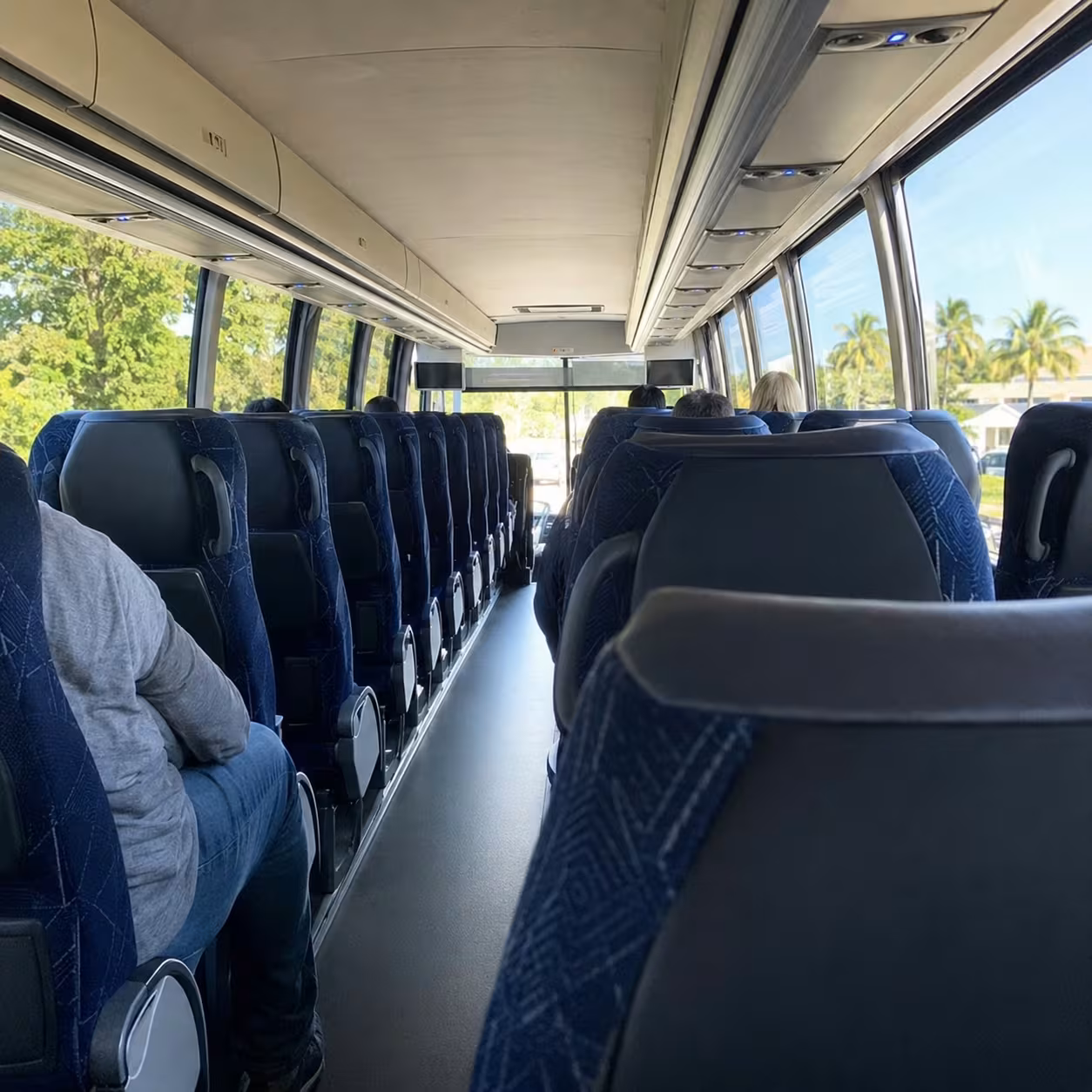 Spacious motorcoach interior with reclining seats for a Punta Gorda airport transfer to Naples, Florida
