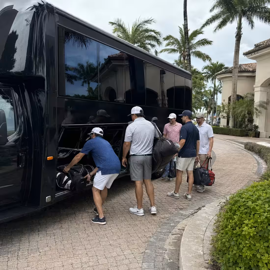Party bus loading golf and weekend bags at a Naples golf club for a bachelor party