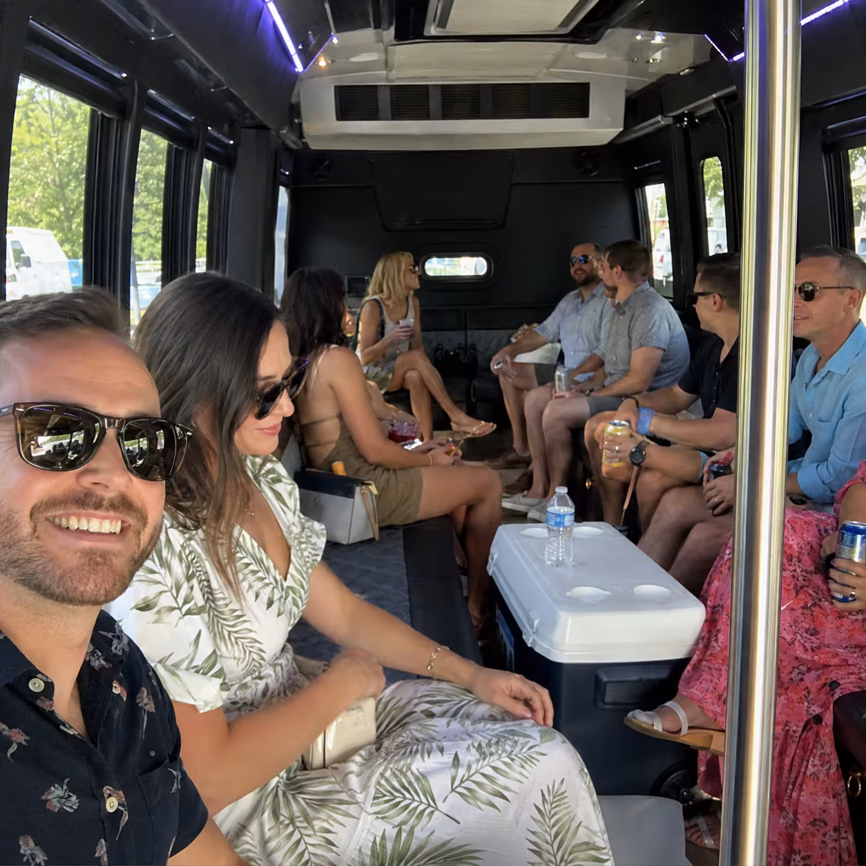 Party bus interior with a cooler between brewery and distillery stops in Naples