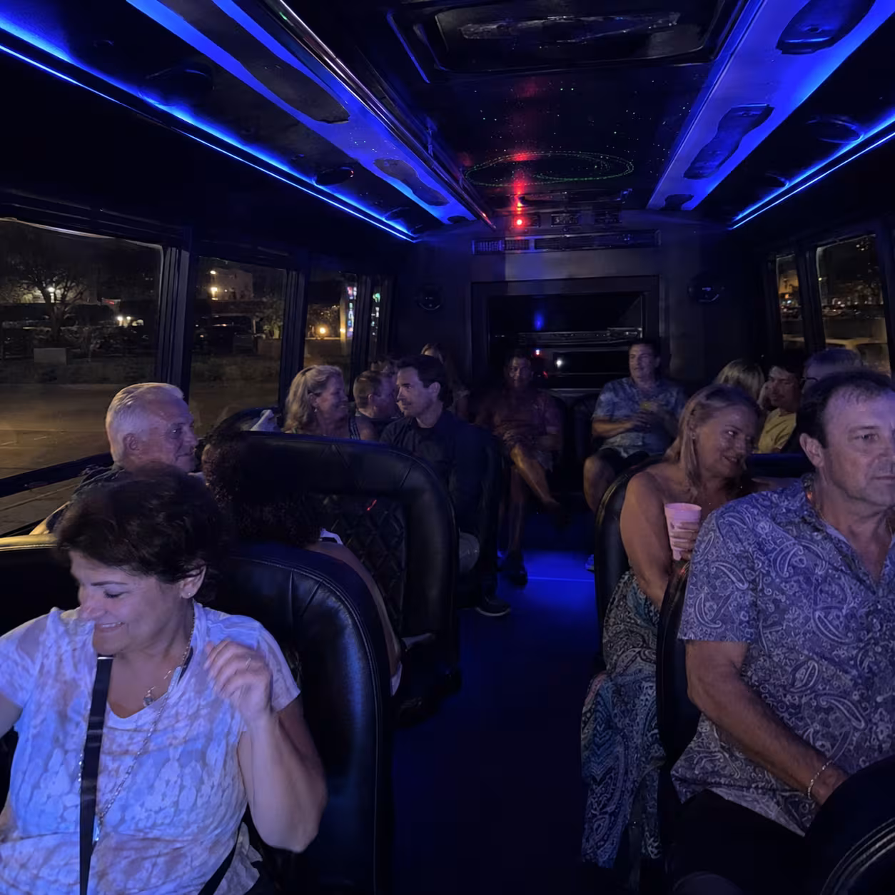 Party bus interior with LED lighting on a late-night return in Naples