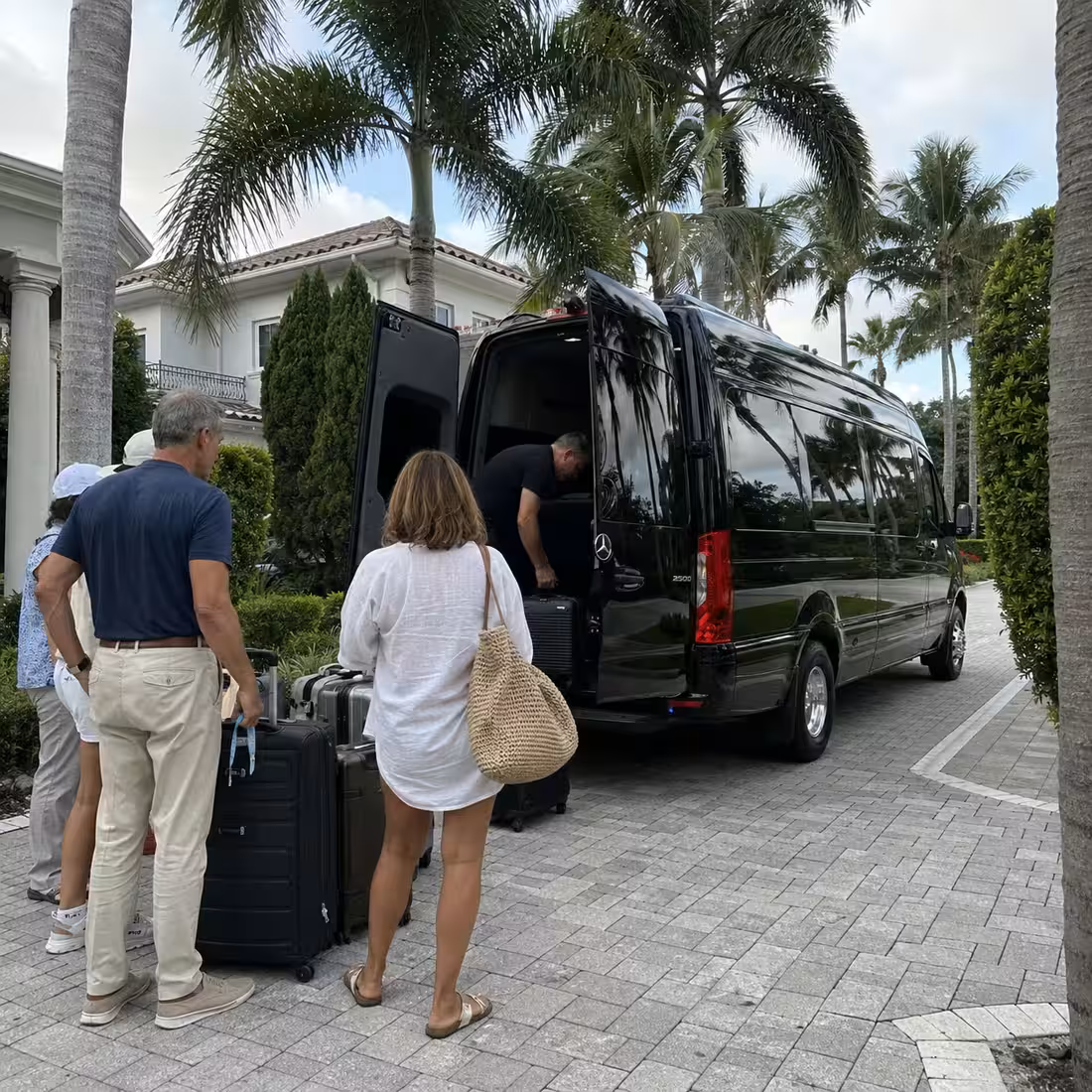 Sprinter limo loading weekend luggage at a Naples hotel or Airbnb driveway