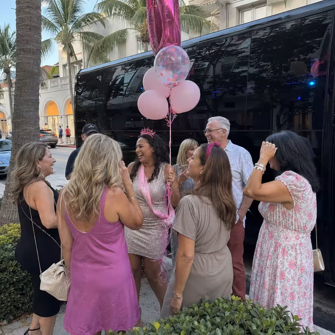 Adult birthday group beside a party bus on Fifth Avenue South in Naples, Florida