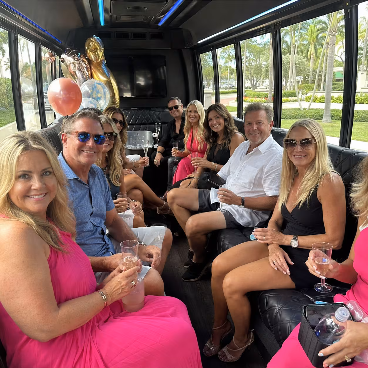 Adults celebrating inside a party bus with LED lighting in Naples, Florida