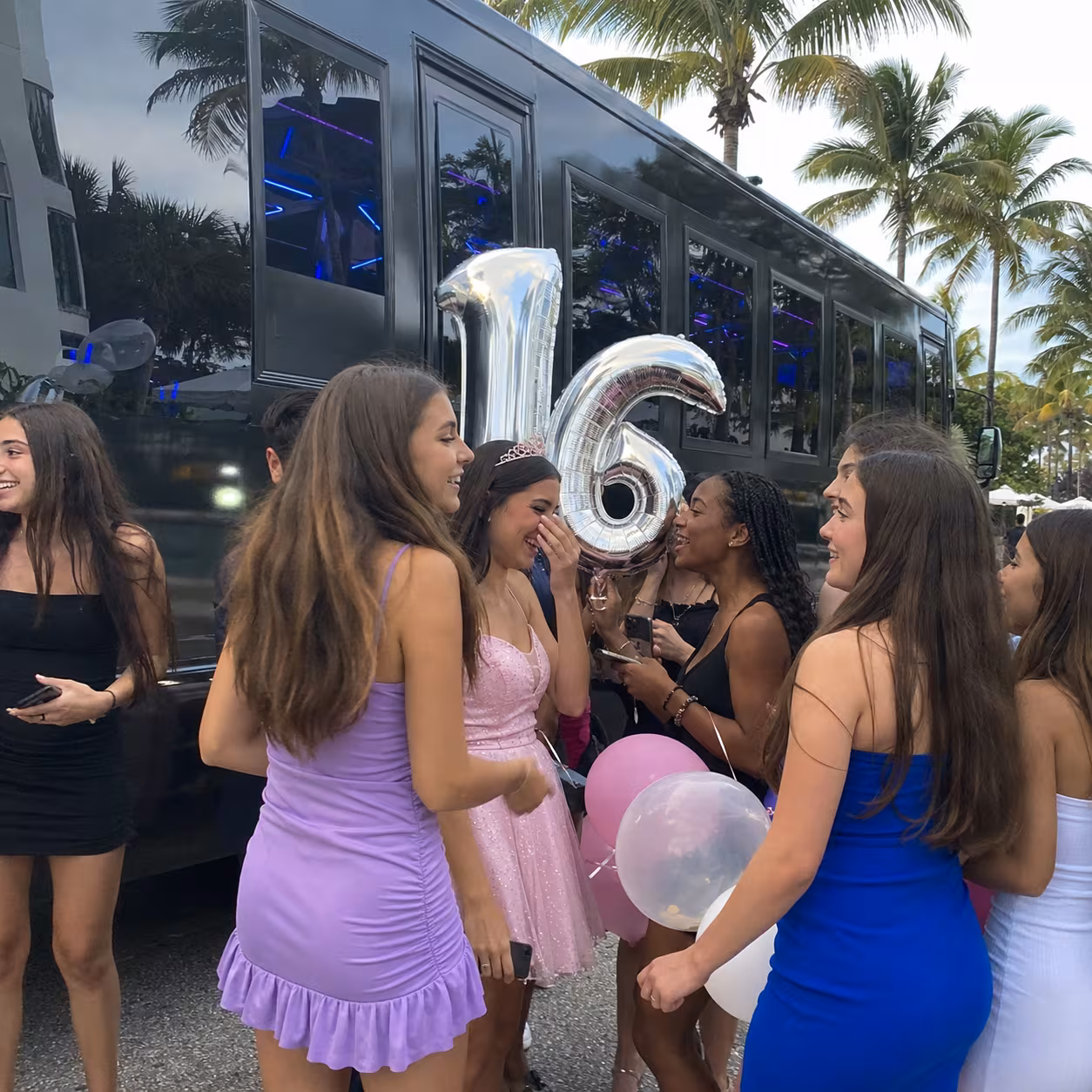 Sweet 16 birthday group outside a black party bus in Naples, Florida