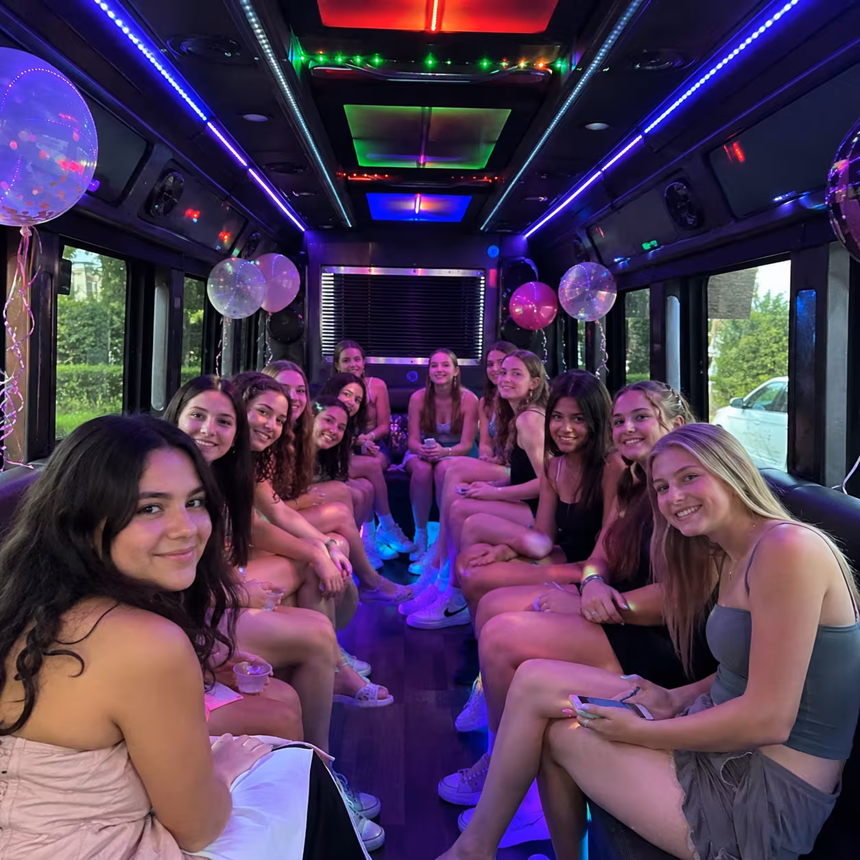 Sweet 16 celebration inside a party bus with colorful LED lighting in Naples, Florida