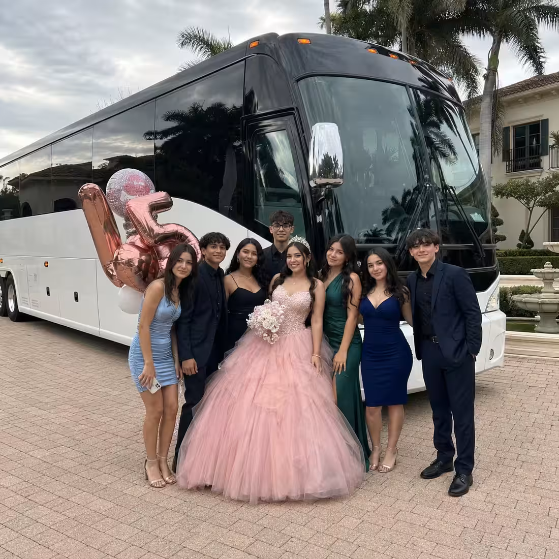 Quinceañera group beside a Grech MCI coach in Naples, Florida