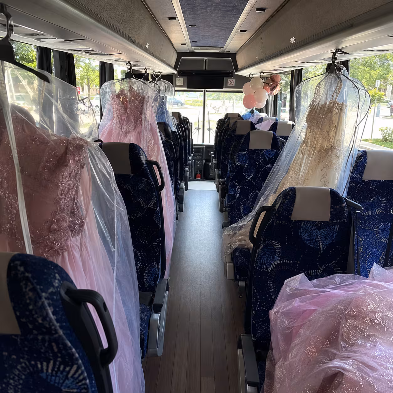 MCI coach interior with quinceañera dresses in garment bags in Naples, Florida