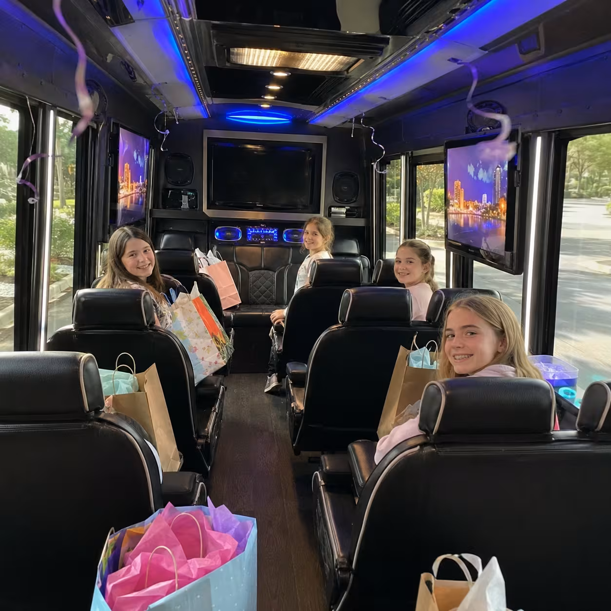 Kids' birthday minibus interior with gift bags and entertainment screens in Naples, Florida