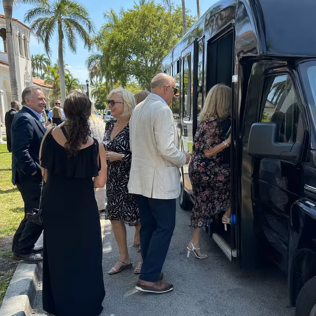 Group boarding a minibus near Cambier Park for a concert in Naples, Florida