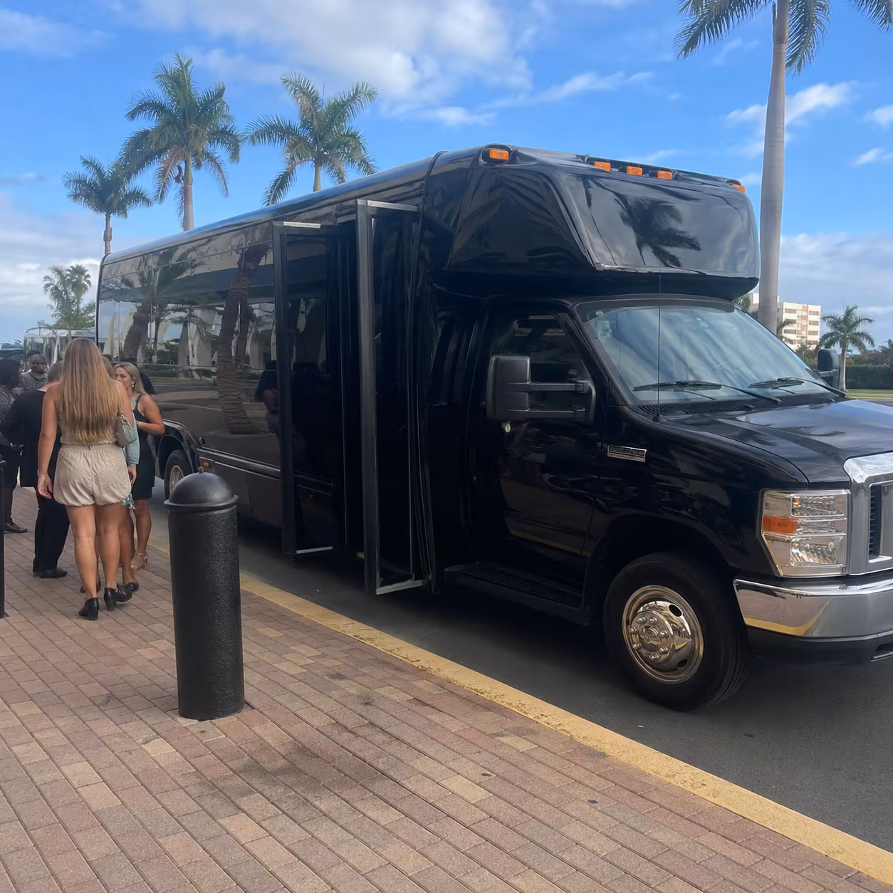 Black party bus parked outside an arena for a concert in Southwest Florida
