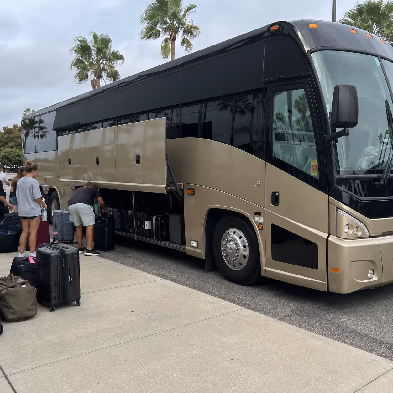MCI J4500 motorcoach luggage bay loaded for a concert road trip in Naples, Florida