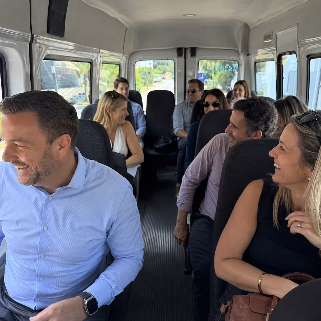 Corporate retreat group seated aboard a minibus in Naples, Florida