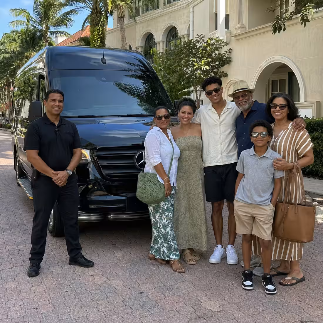 Driver checking in guests at a Sprinter van for a Naples private event