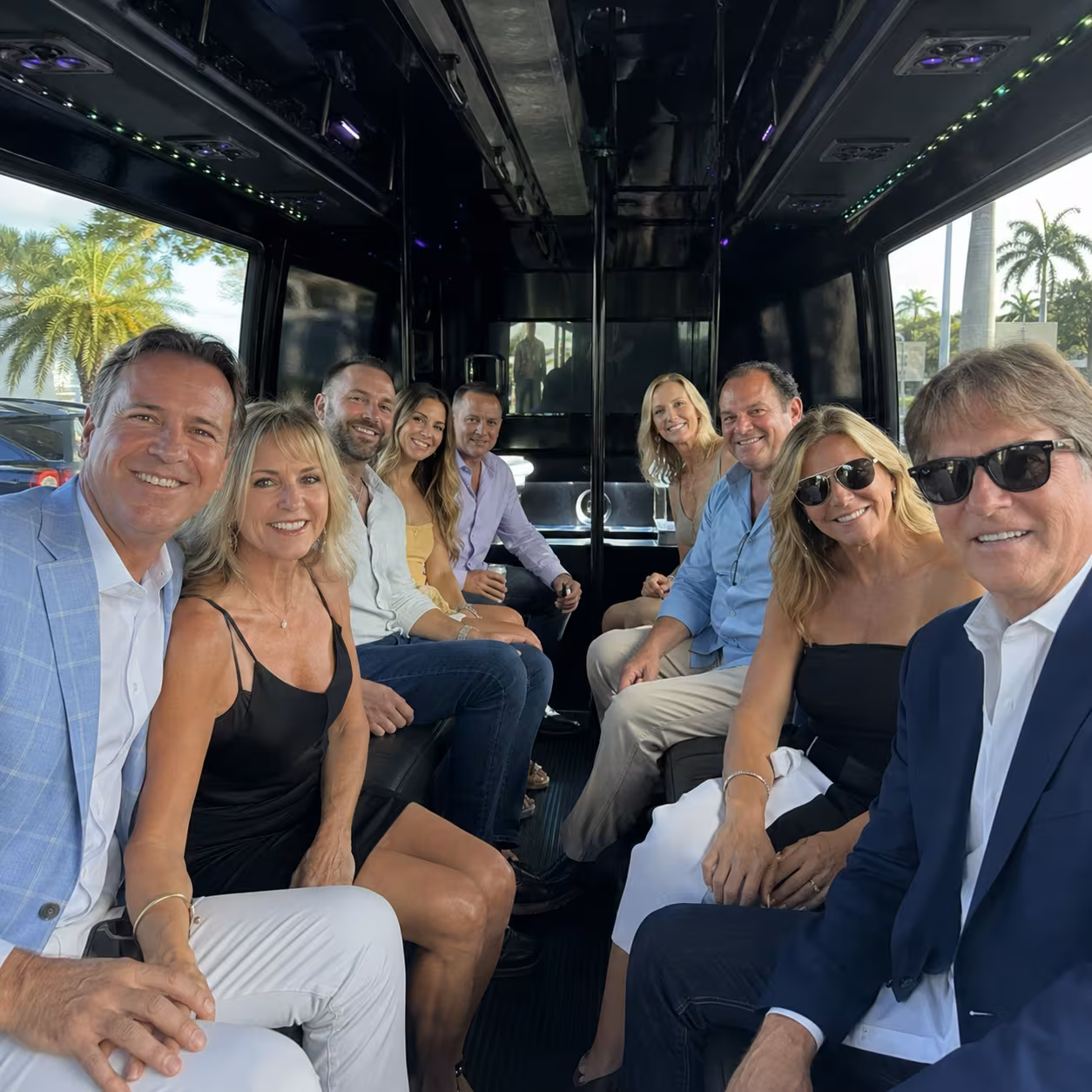 Friends enjoying a party bus interior for a private event in Naples, Florida