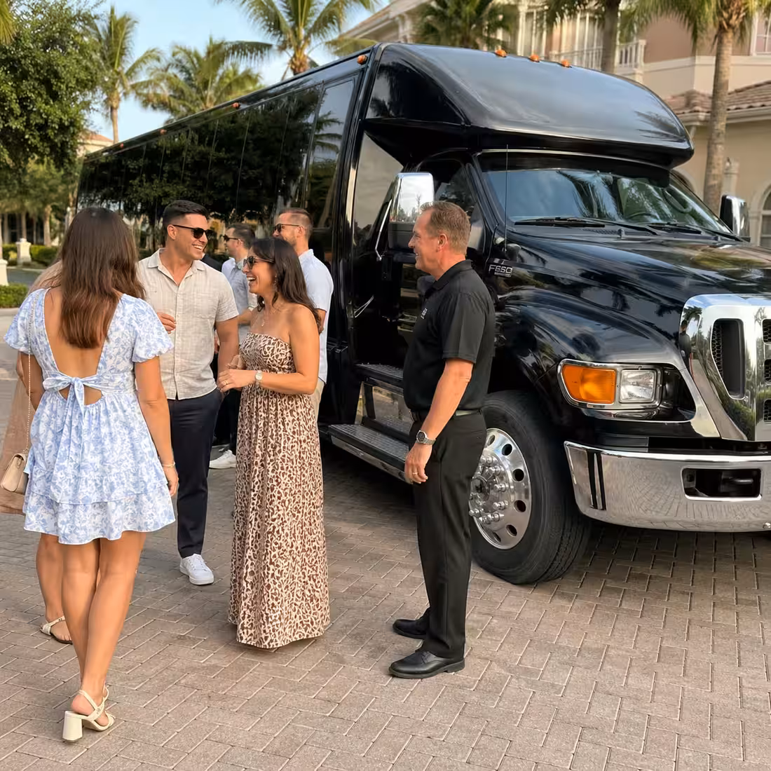Driver at the door of a cutaway shuttle for a Naples private event