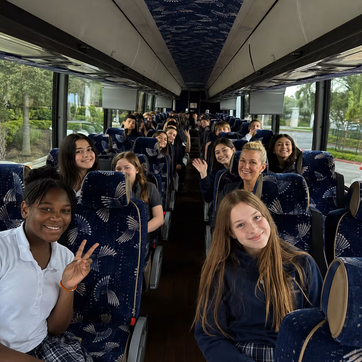 Students seated aboard an MCI J4500 motorcoach for a school trip in Naples, Florida